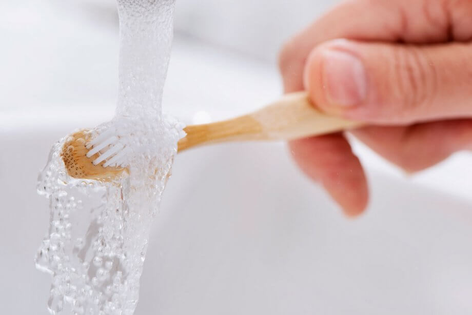 running water over a toothbrush