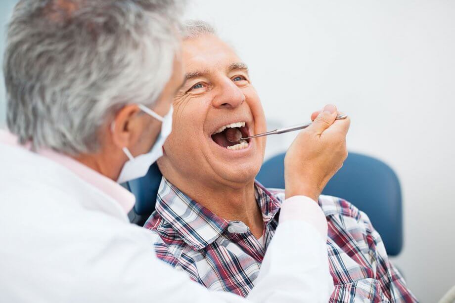 dentist looking inside a patients mouth
